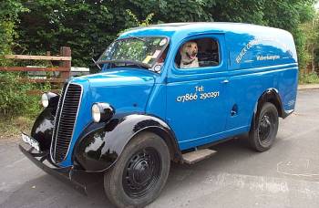I think this is a Ford van - don't know year or model - (or make?)   I was surprised the dog could reach the pedals